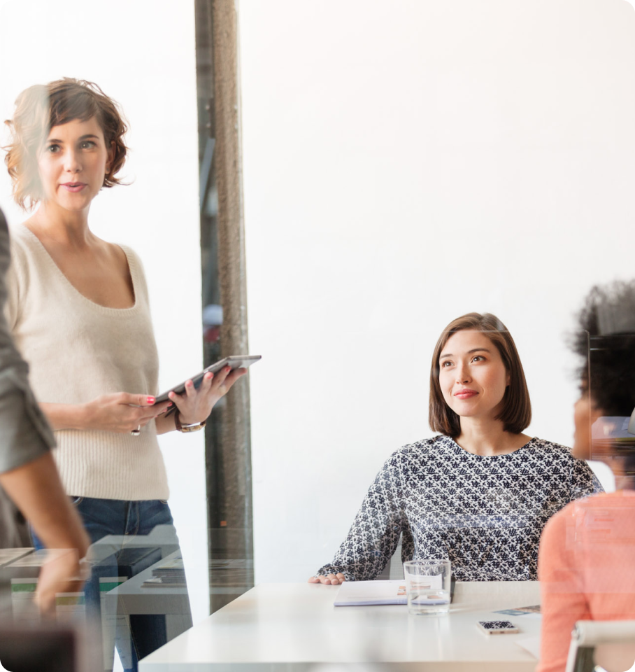 Image of diverse professionals in an office discussing utilization management.