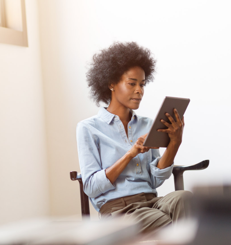 Image of black female healthcare professionals analyzing tablet screen.