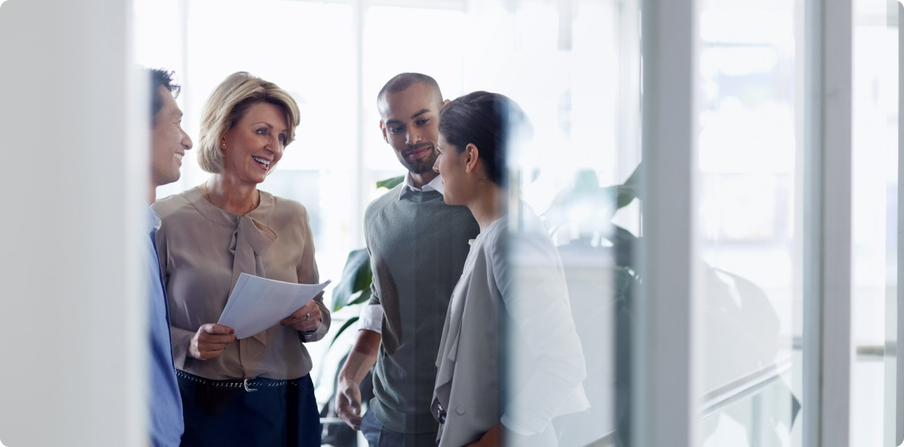 Image of four diverse healthcare professionals having a conversation.