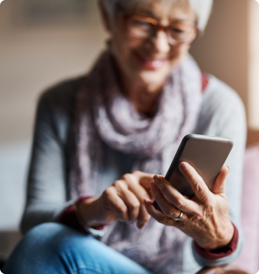 Image of old woman typing on a phone.