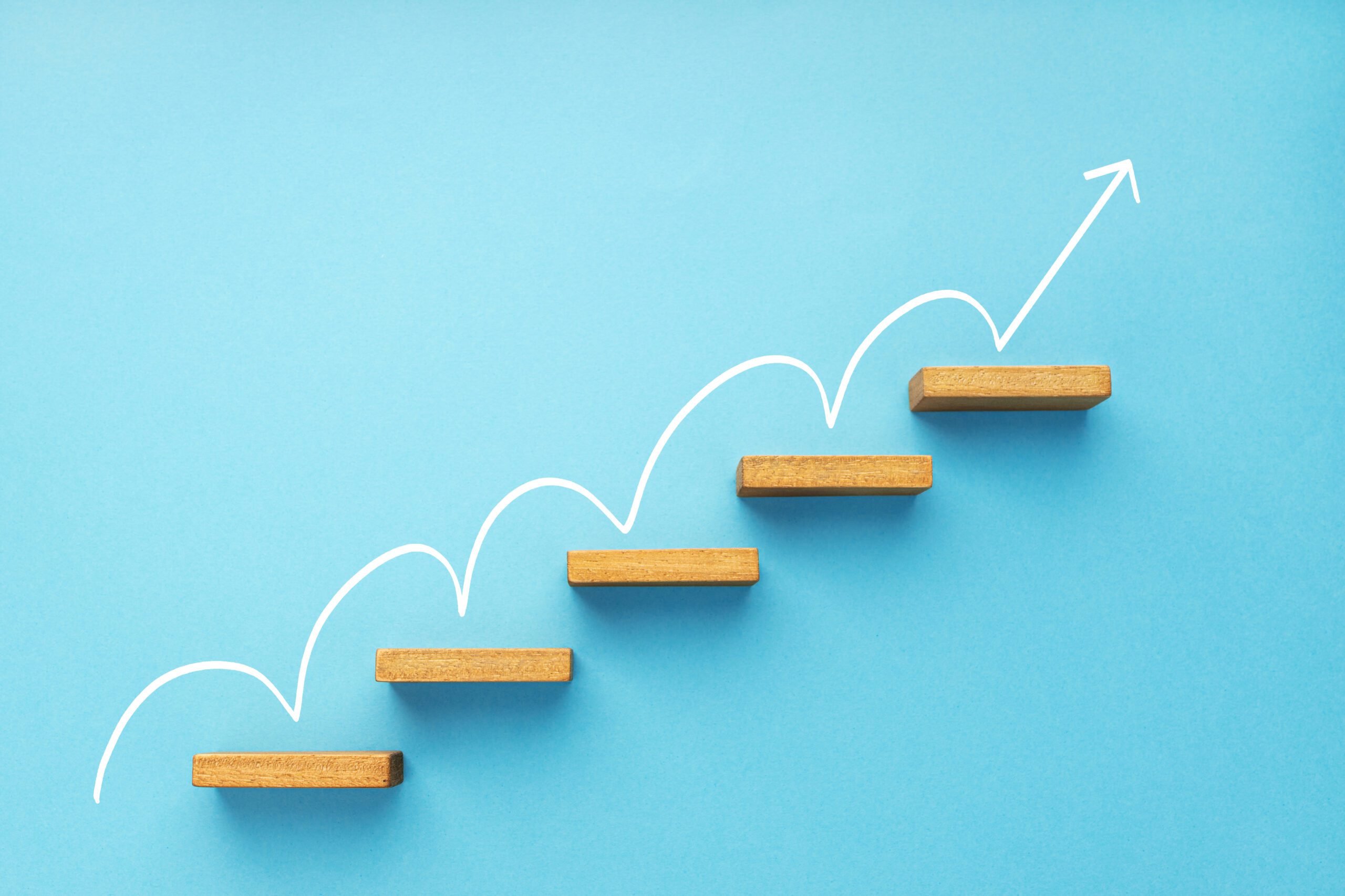 Rising arrow on staircase on blue background growth, increasing
