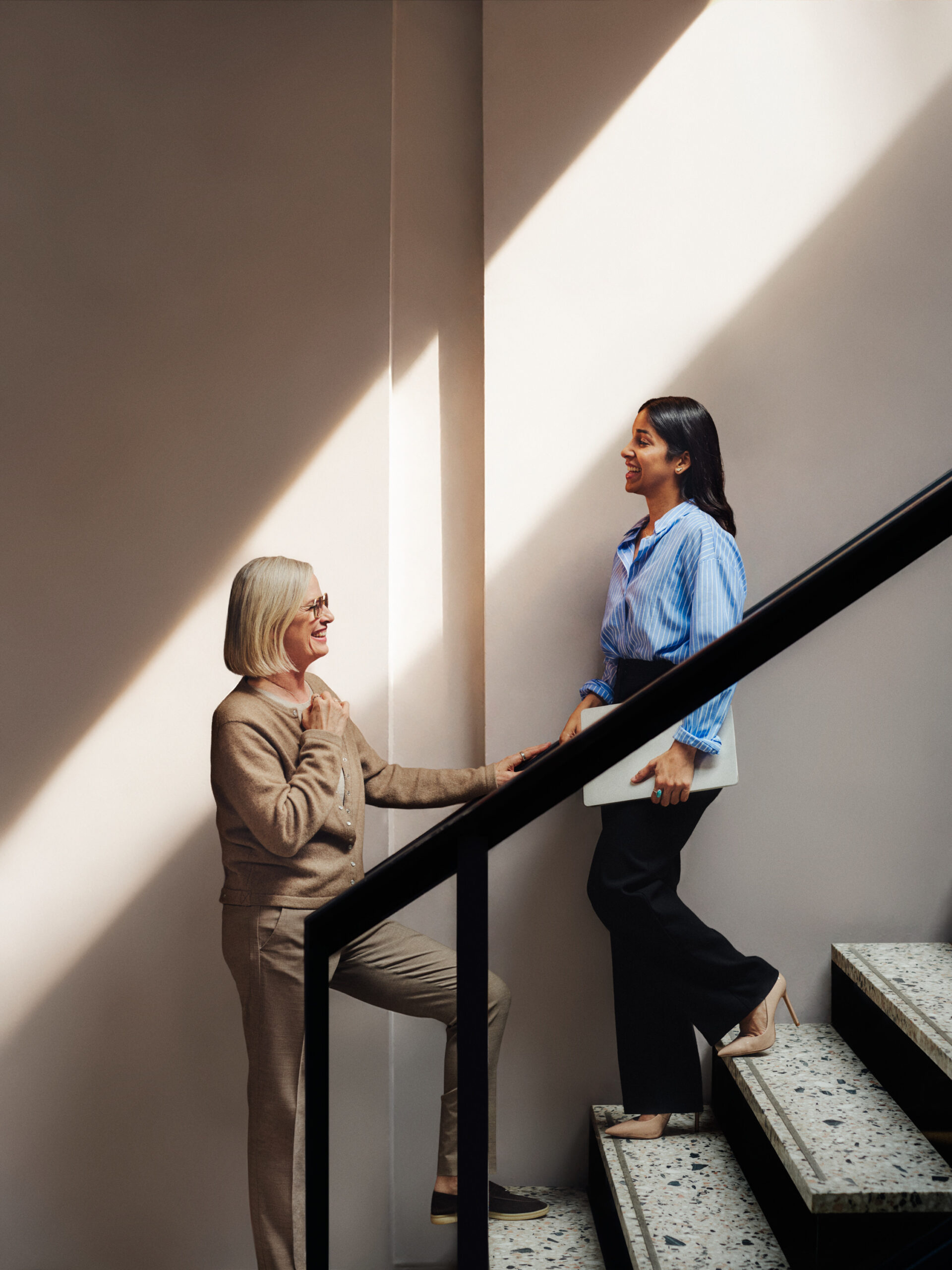 female coworkers chatting on stairs